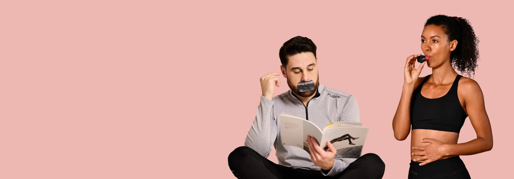 Ein Mann im Schneidersitz mit einem schwarzen Mouth Tape auf dem Mund und einer Zeitschrift in der Hand. Daneben steht eine Frau mit einem ARTZT neuro Atemtrainer im Mund | Holistic Health